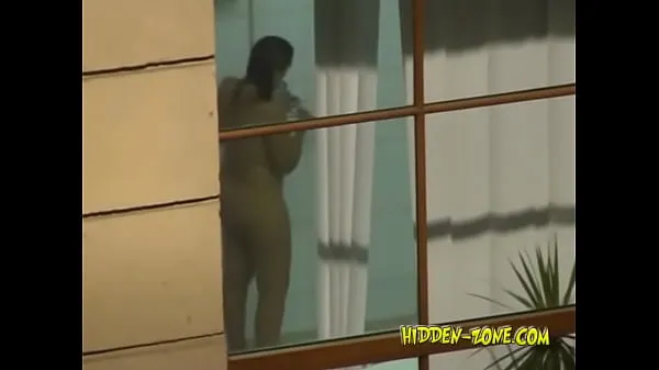 Big A girl washes in the shower, and we see her through the window warm Tube