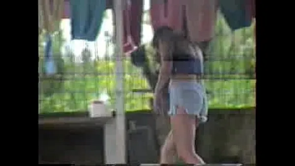 بڑی Sula laying out clothes in the backyard in short shorts گرم ٹیوب