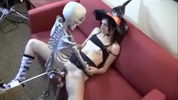 Big witch giving to skull warm Tube