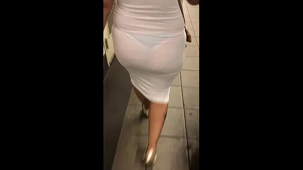 Grote Wife in see through white dress walking around for everyone to see warme buis