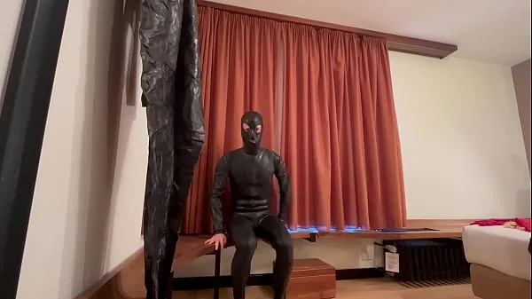 Grande Latexitaly is wearing a very tight black latex catsuittubo caldo