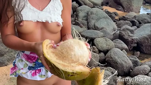 Big Naked girl found a coconut on a public beach and poured the juice over her body warm Tube