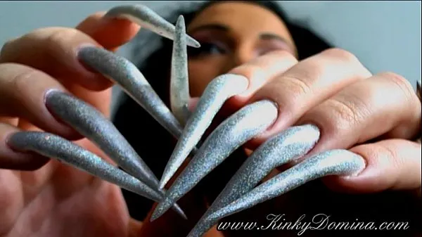 Big long sharp fingernails in holographic silver, fingernails flicking warm Tube